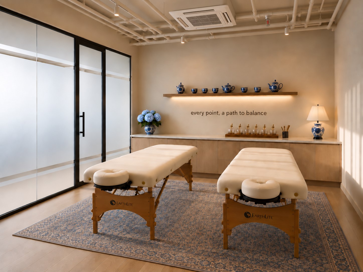 Modern couples acupuncture room for commercial wellness clinics featuring two treatment tables, calming interiors, custom millwork, and a patient-centered healthcare design.